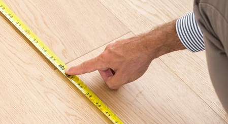 Man measuring floor | Flooring and More