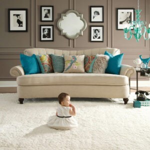 Baby sitting on carpet floor | Flooring and More